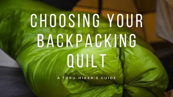 Green backpacking quilt relaxed inside a tent